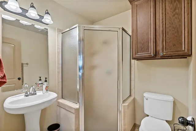 a bedroom with a bed and a table with wooden floor