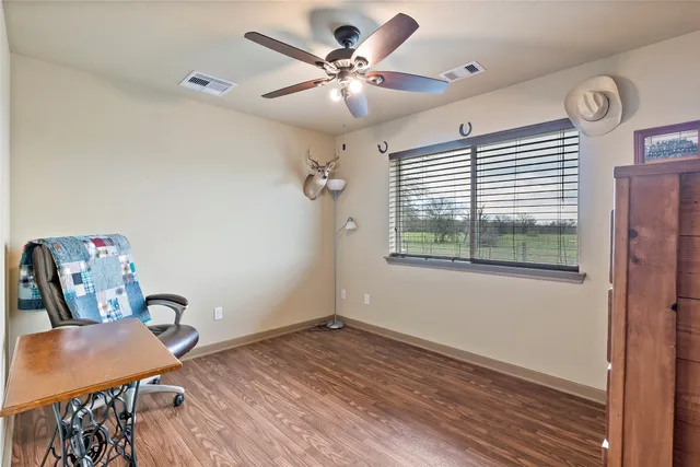 a bathroom with a granite countertop sink a mirror and a shower