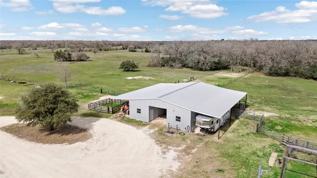an aerial view of a house with a yard and lake view
