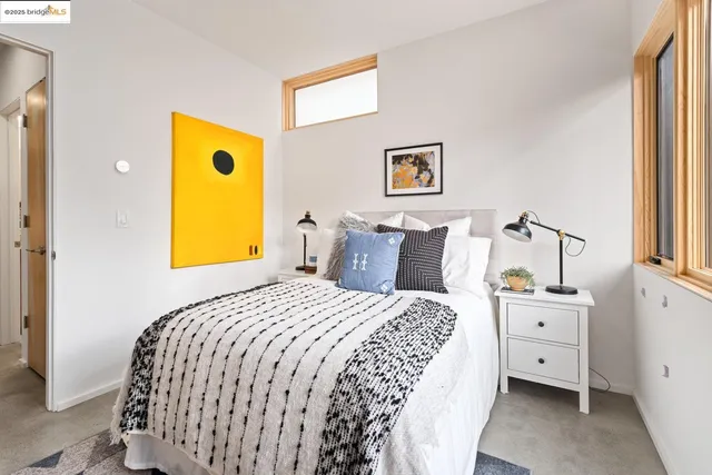 a bed sitting in a bedroom next to a window