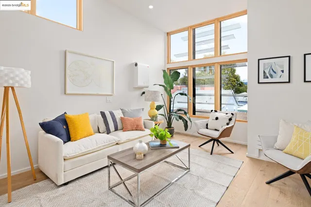 a living room with furniture and floor to ceiling windows