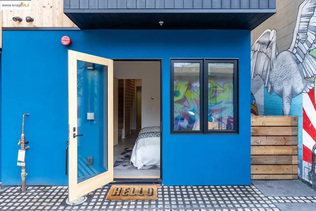 a view of a hallway with a door and couch