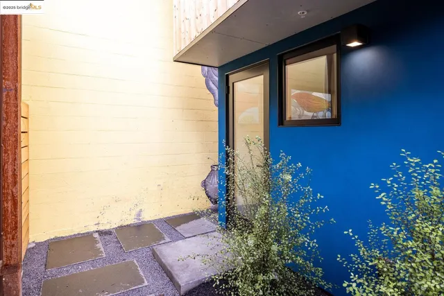 a front view of a house with plants