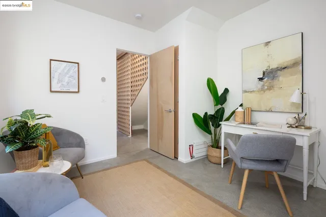 a living room with furniture and a potted plant