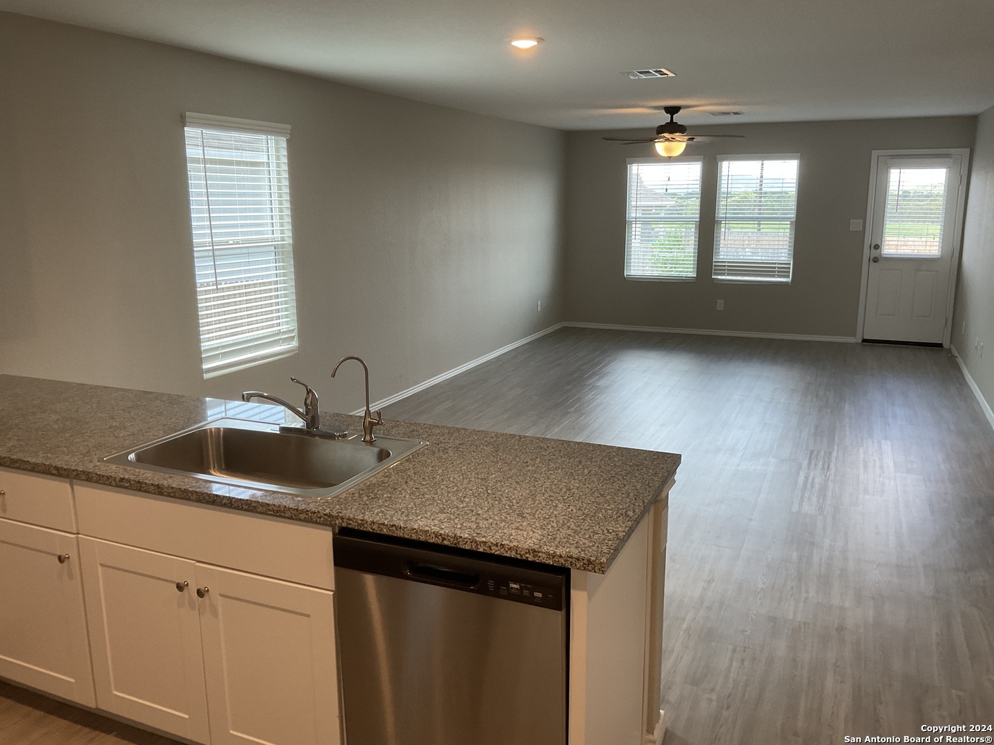 5813 Companion Loop Bulverde, TX 78163 - Photo 3 of 28 a kitchen with a sink a window and cabinets