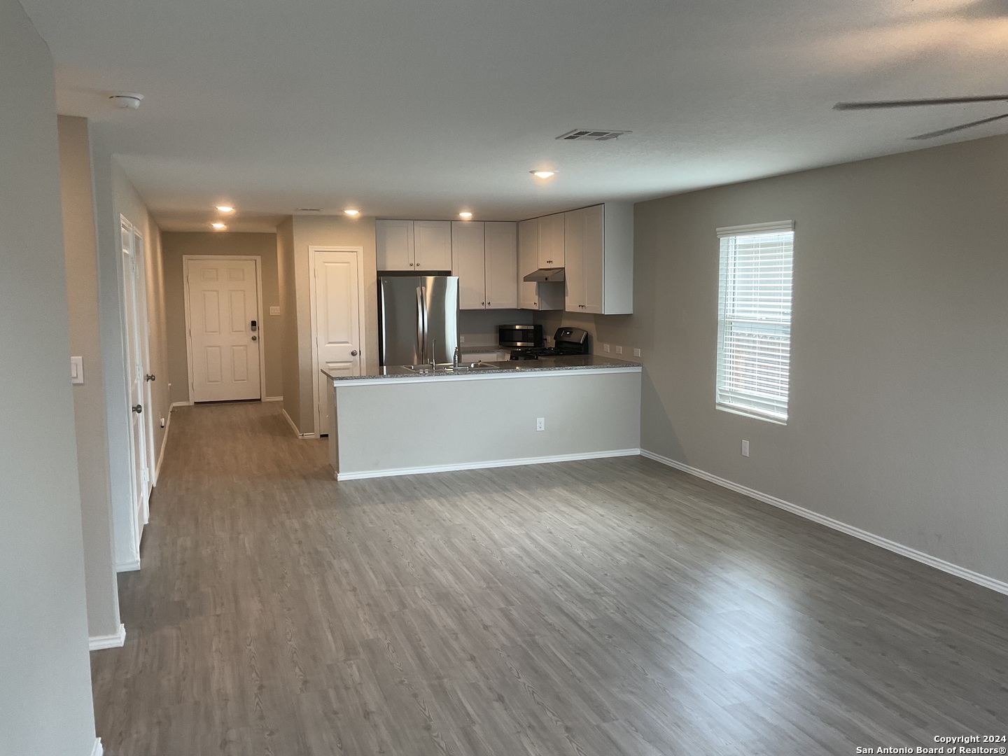 5813 Companion Loop Bulverde, TX 78163 - Photo 5 of 28 a view of a kitchen with a sink and wooden floor