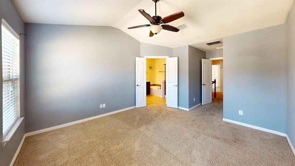 392 Dublin Street Lewisville, TX 75067 - Photo 11 of 21 an empty room with windows and a ceiling fan