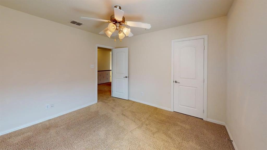 392 Dublin Street Lewisville, TX 75067 - Photo 12 of 21 a view of an empty room with a chandelier fan