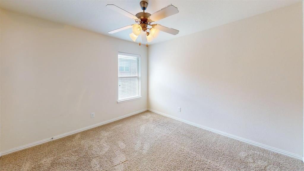 392 Dublin Street Lewisville, TX 75067 - Photo 13 of 21 a view of a chandelier fan in a room