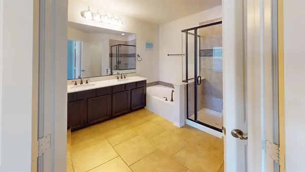 a bathroom with a tub sink and mirror