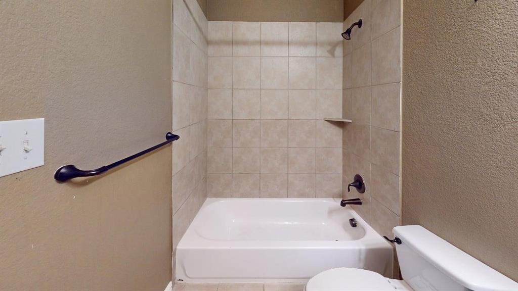 392 Dublin Street Lewisville, TX 75067 - Photo 18 of 21 a bathroom with a bathtub and a shower