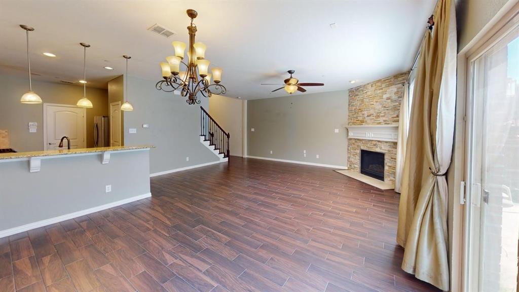 392 Dublin Street Lewisville, TX 75067 - Photo 6 of 21 a view of a livingroom with wooden floor and a ceiling fan