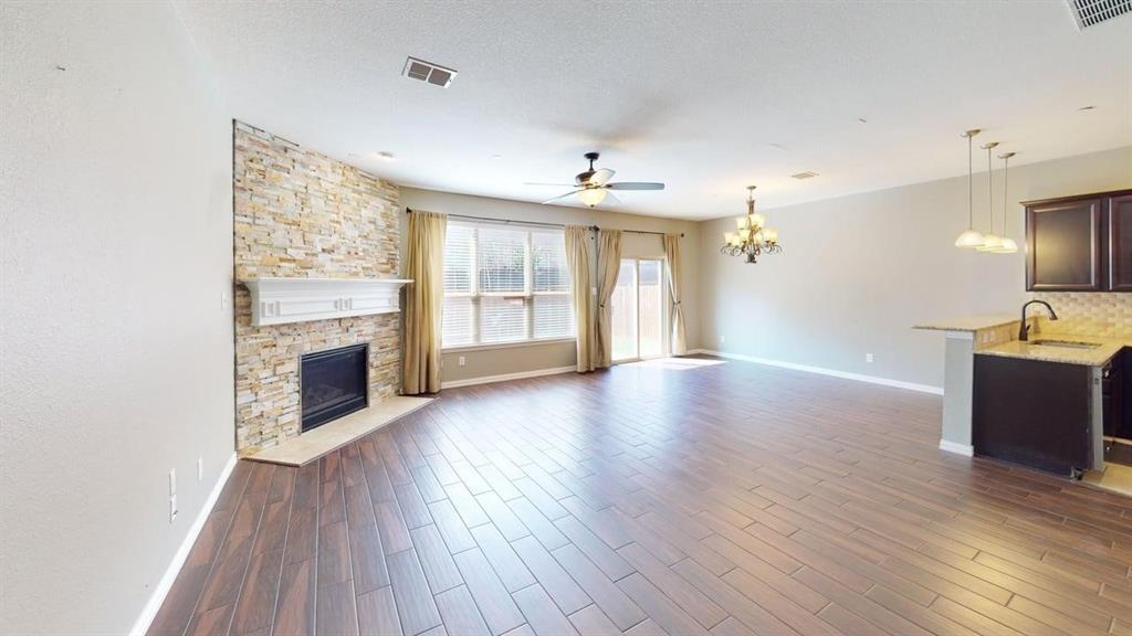 392 Dublin Street Lewisville, TX 75067 - Photo 7 of 21 a view of an empty room with window and wooden floor