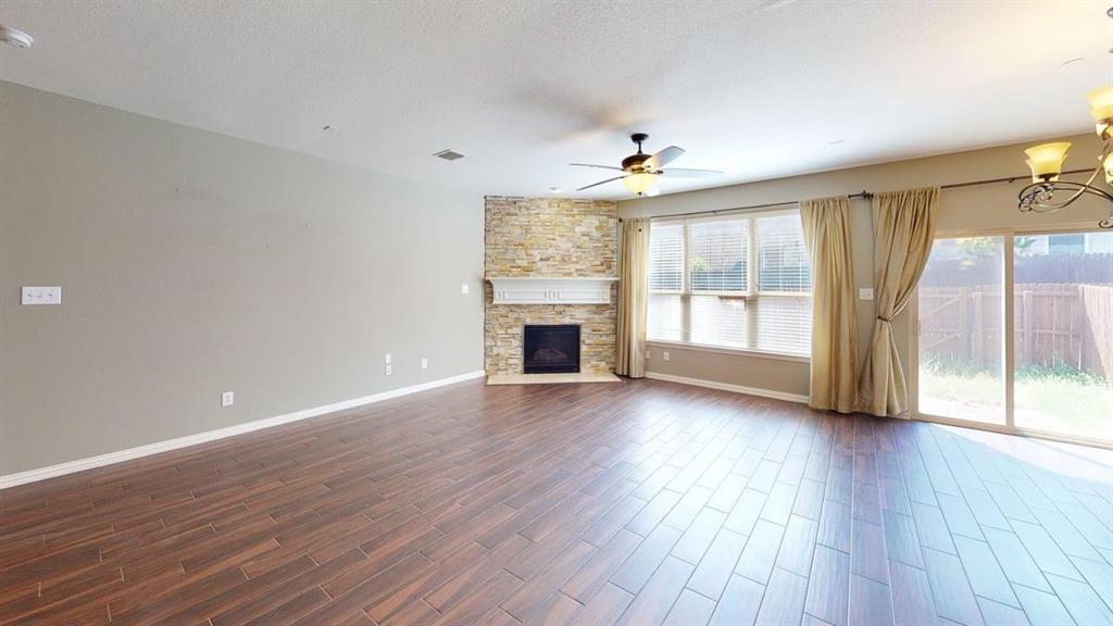 392 Dublin Street Lewisville, TX 75067 - Photo 8 of 21 an empty room with wooden floor fireplace and windows