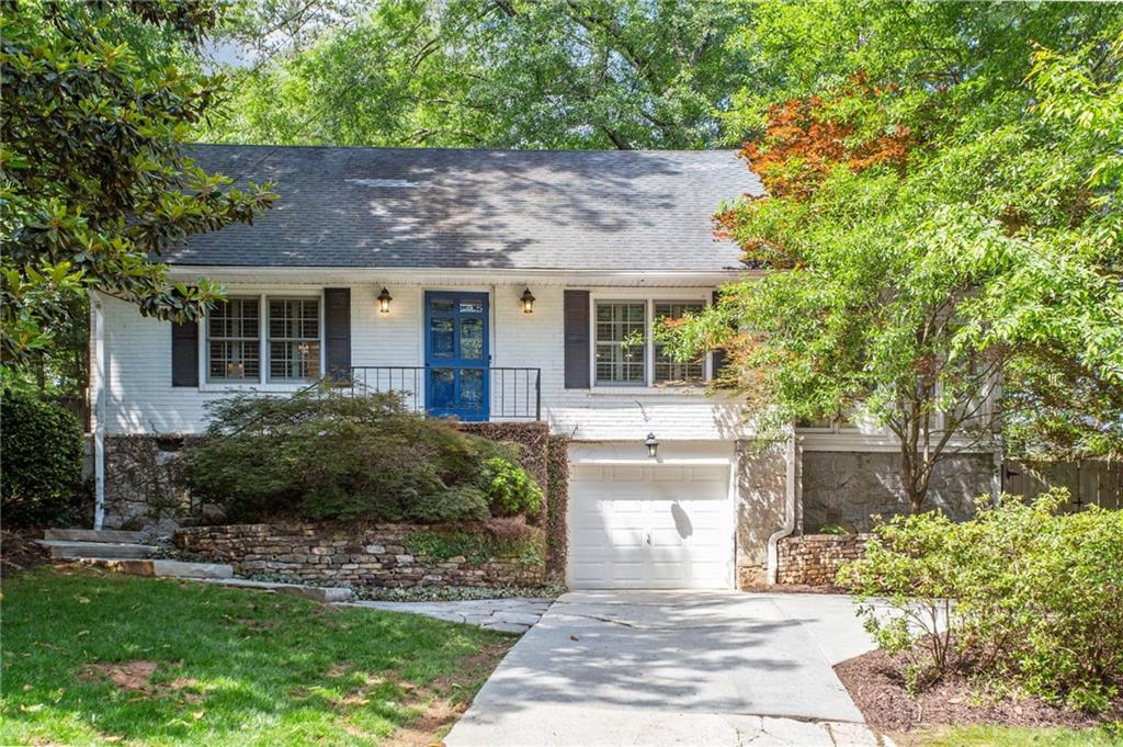 2785 Ridgemore Road Northwest Atlanta, GA 30318 - Photo 1 of 1 a front view of a house with a garden