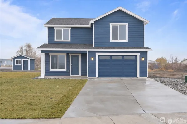 a view of an house with backyard space and balcony