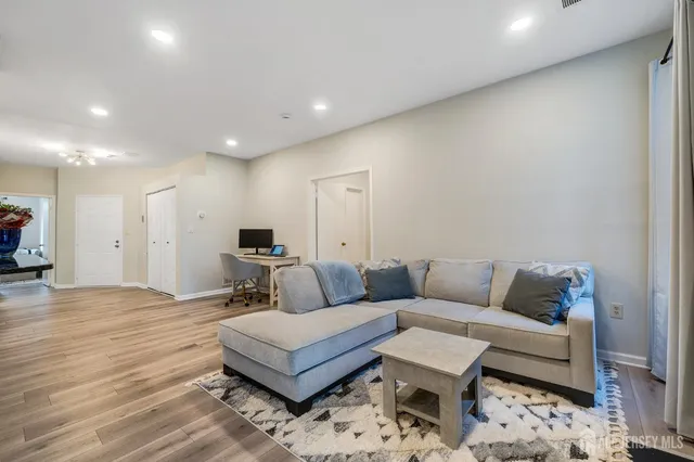 a living room with furniture and a wooden floor