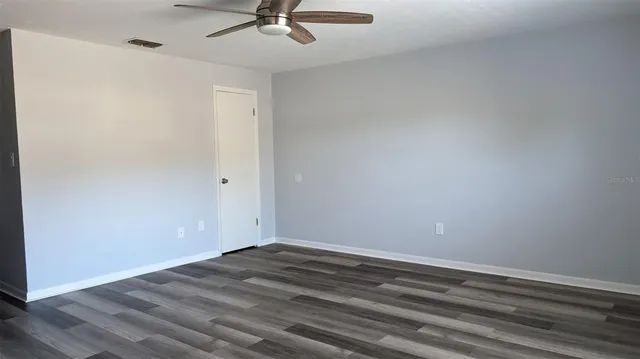 a view of a room with wooden floor