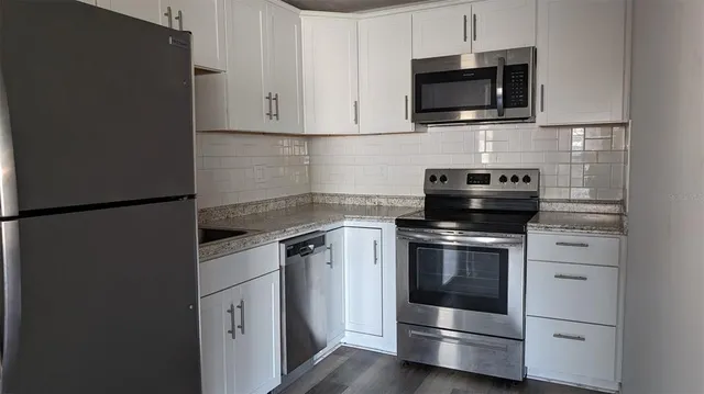 a kitchen with a stove and a microwave