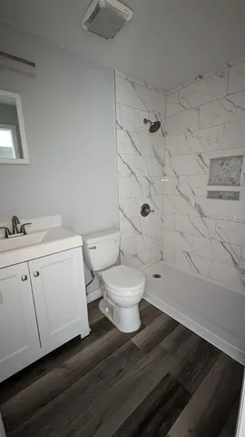 a bathroom with a toilet sink and shower