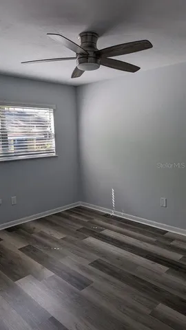 a view of room with window and wooden floor