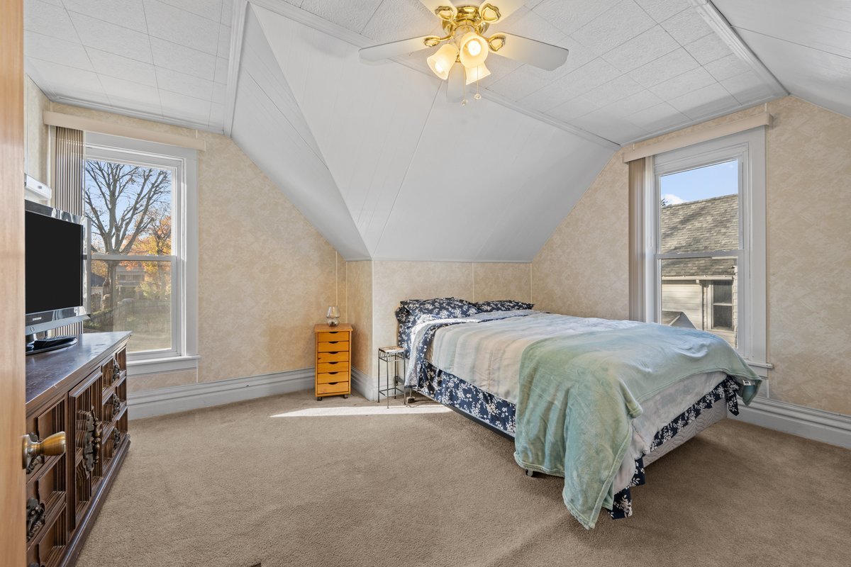 644 Oak Avenue Aurora, IL 60506 - Photo 15 of 21 a bedroom with a bed and a flat tv screen on dresser