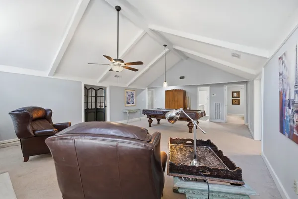 a living room with furniture a window and gym equipment