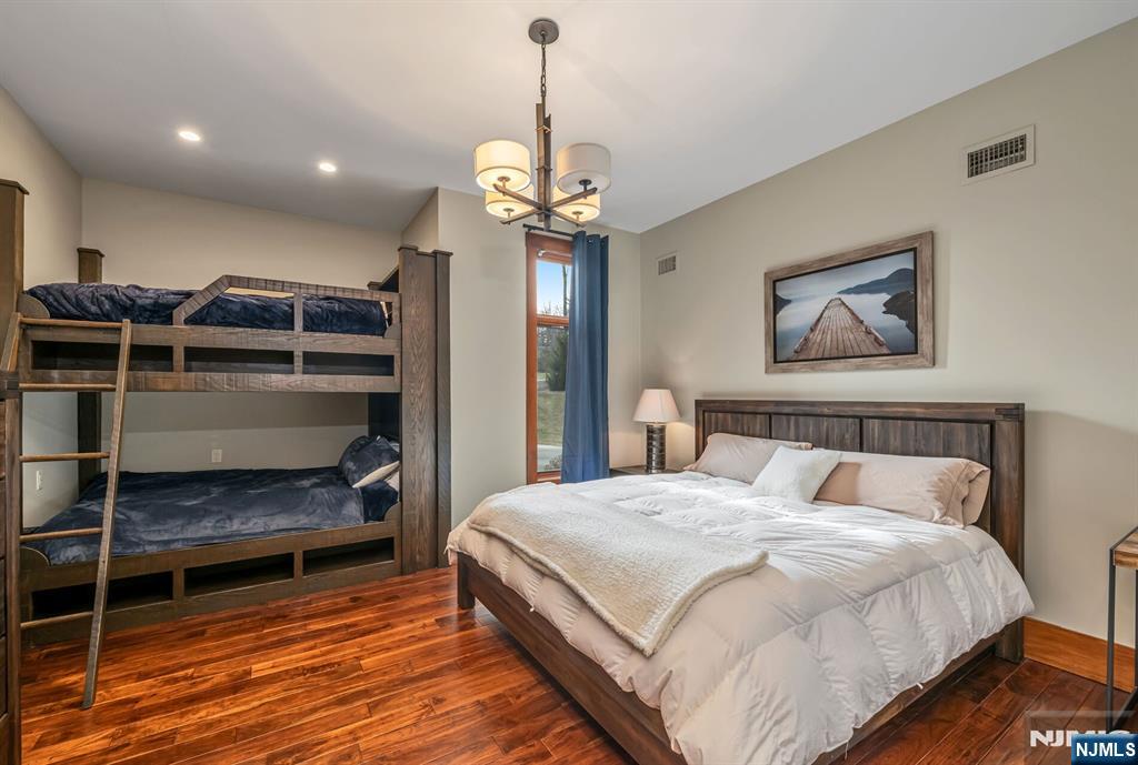 1 Lakeview Point Avenue Branchville, NJ 07826 - Photo 19 of 50 a bedroom with a bed and a chandelier