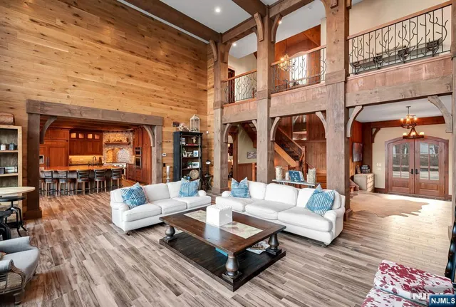a living room with patio furniture and a rug