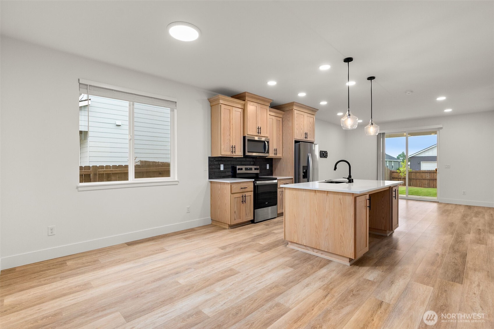 504 Pagget Avenue Winlock, WA 98596 - Photo 4 of 27 a large kitchen with kitchen island a sink a counter space stainless steel appliances and windows