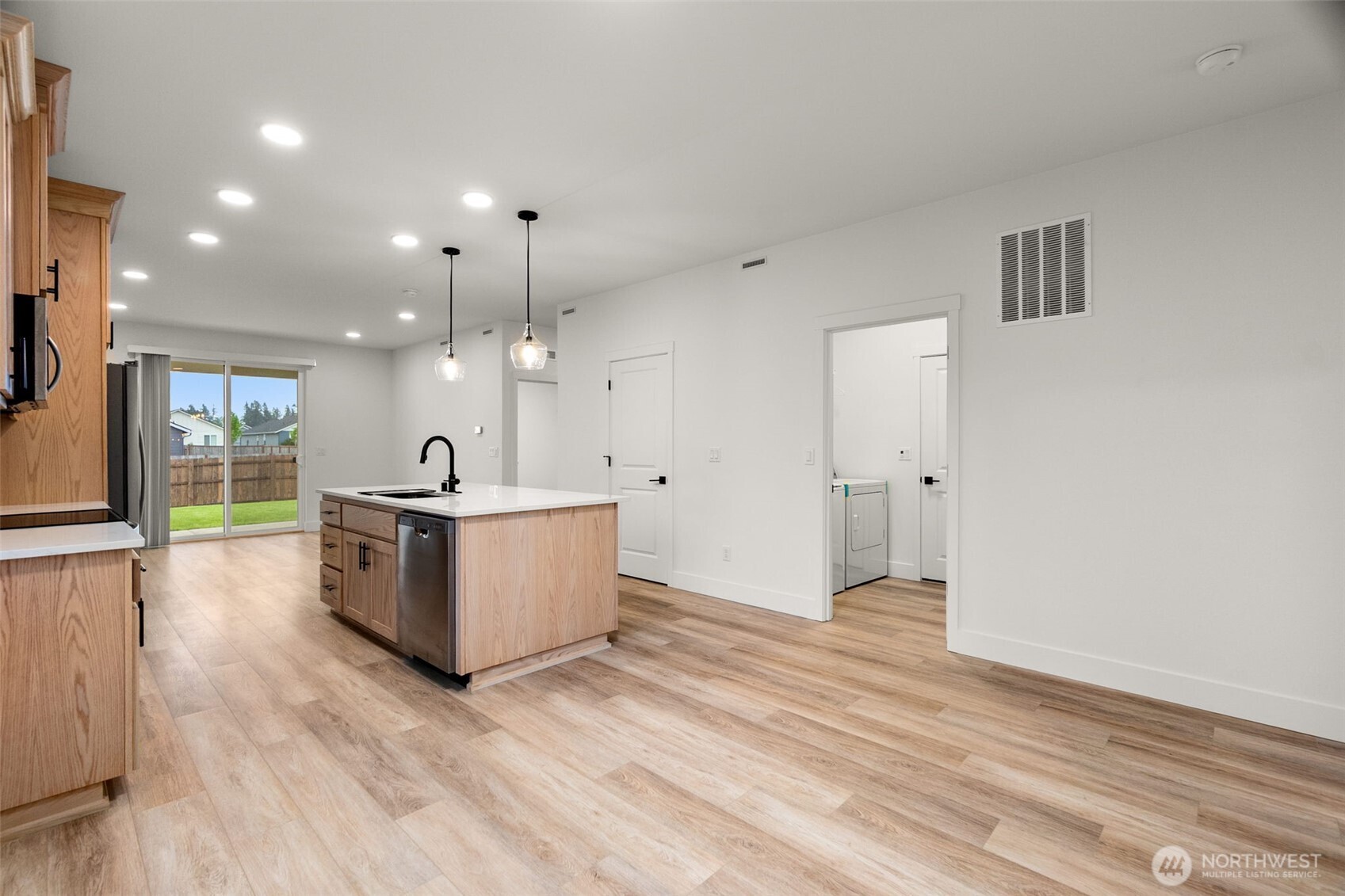 504 Pagget Avenue Winlock, WA 98596 - Photo 5 of 27 a living room with kitchen island furniture and a wooden floor