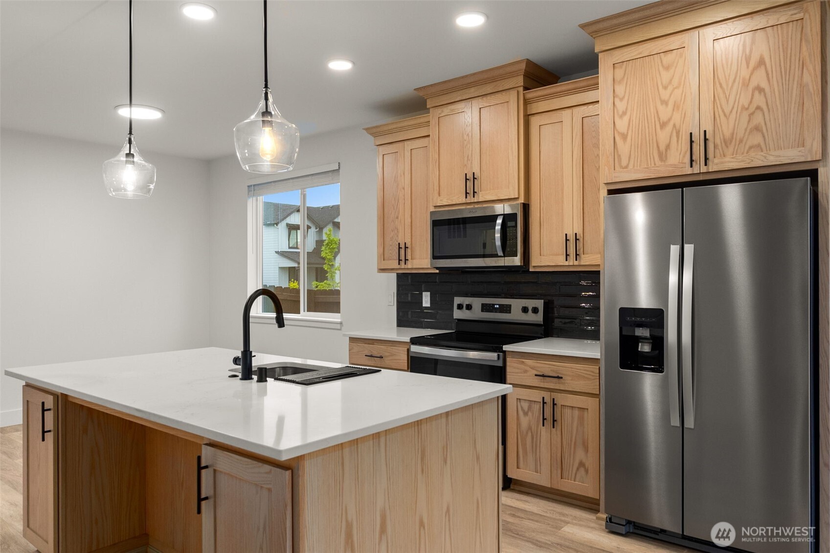 504 Pagget Avenue Winlock, WA 98596 - Photo 7 of 27 a kitchen with kitchen island a sink appliances and cabinets