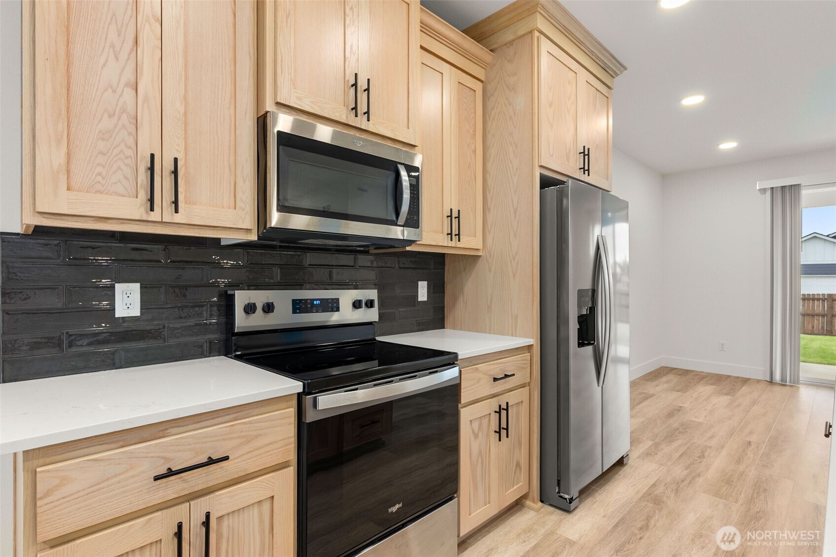 504 Pagget Avenue Winlock, WA 98596 - Photo 8 of 27 a kitchen with stainless steel appliances a stove a microwave and a hard wood floors