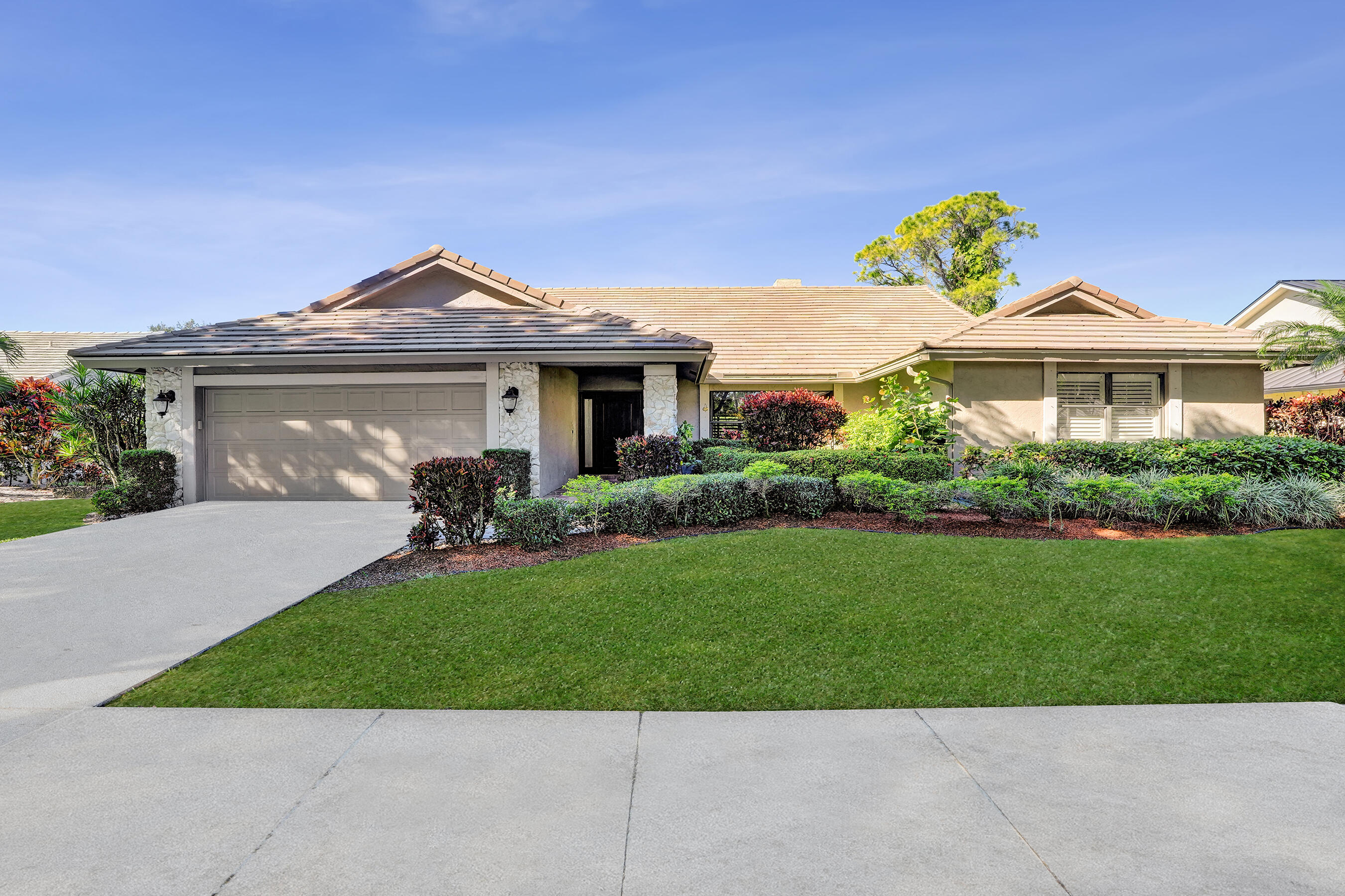 2413 Northwest 40th Circle Boca Raton, FL 33431 - Photo 1 of 66 a front view of a house with a yard
