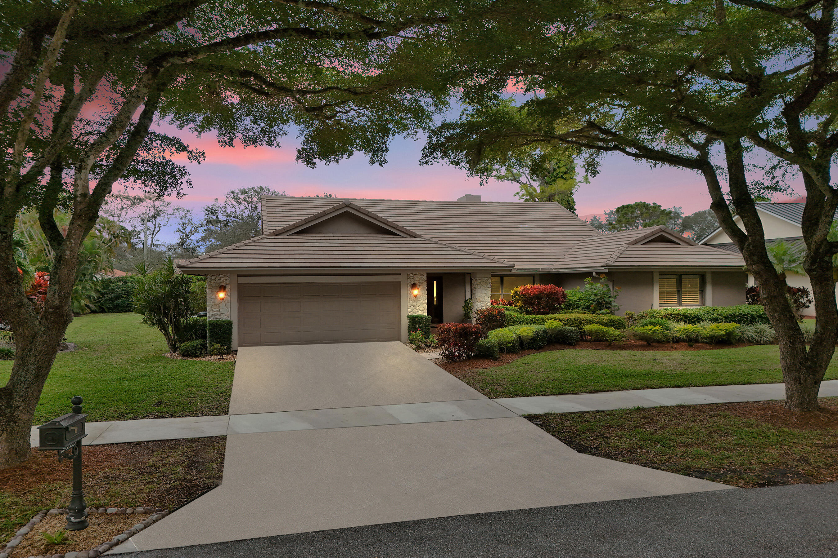 2413 Northwest 40th Circle Boca Raton, FL 33431 - Photo 2 of 66 a front view of a house with a garden
