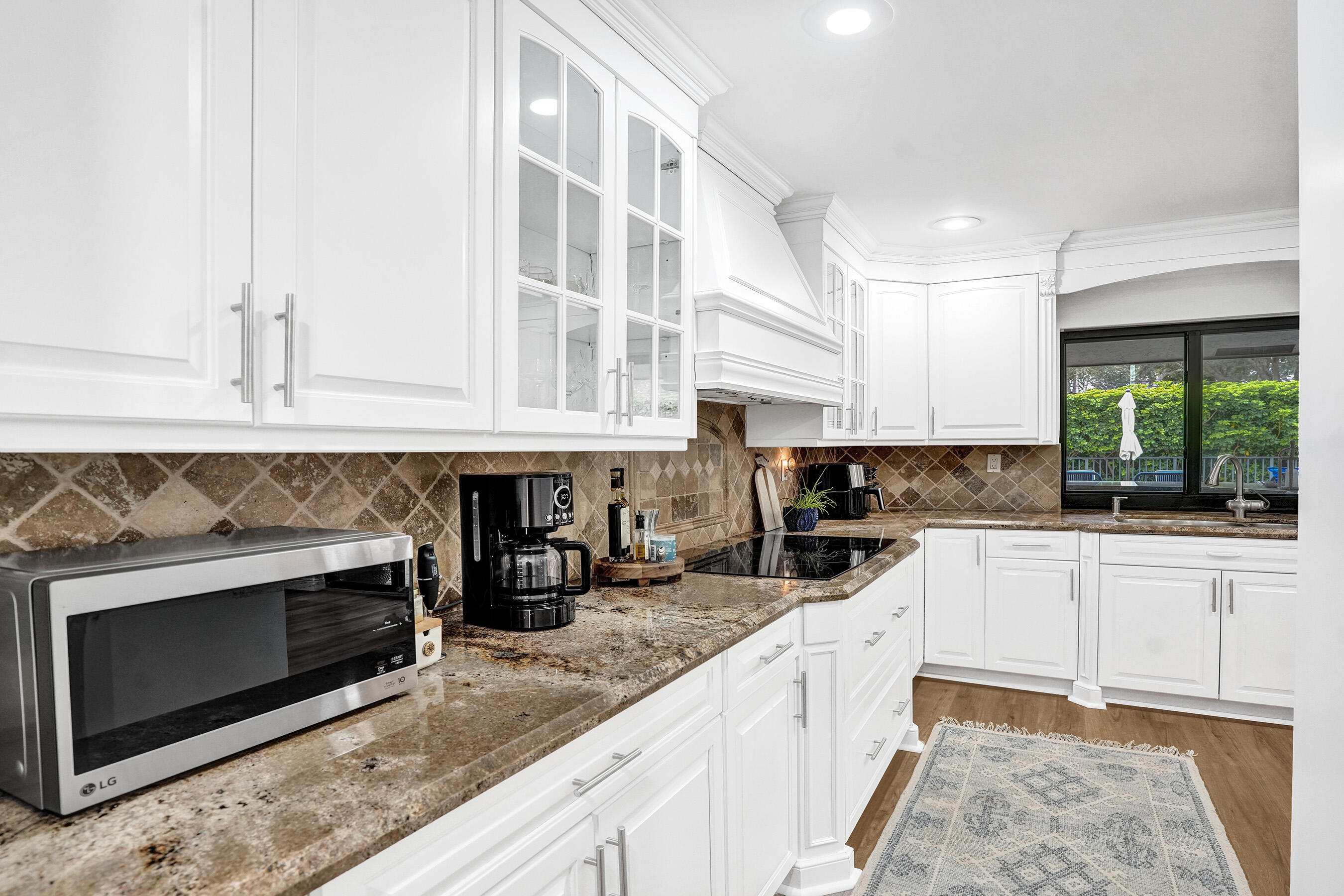 2413 Northwest 40th Circle Boca Raton, FL 33431 - Photo 21 of 66 a kitchen with stainless steel appliances granite countertop a stove and cabinets