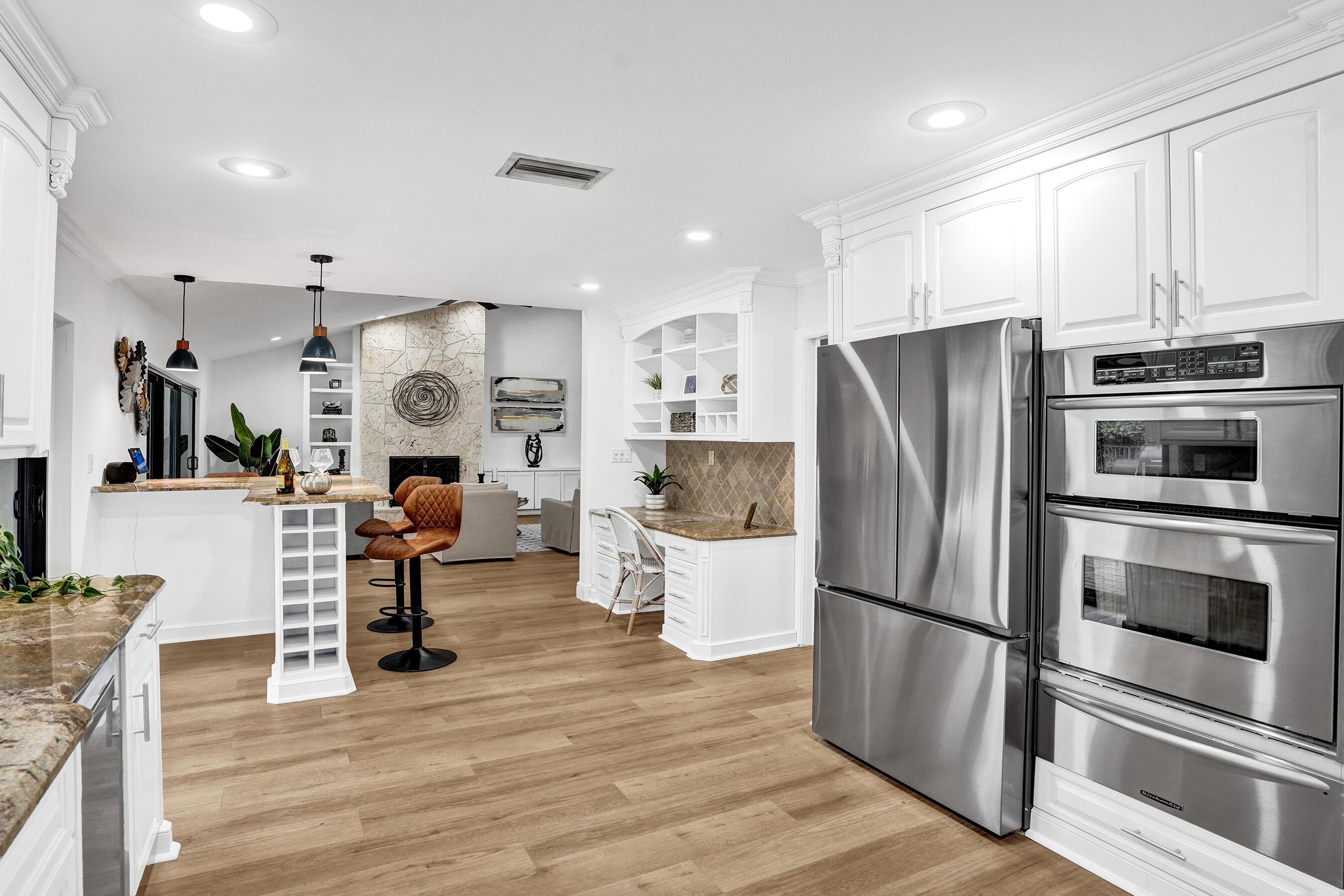 2413 Northwest 40th Circle Boca Raton, FL 33431 - Photo 22 of 66 a kitchen with stainless steel appliances a refrigerator and a stove top oven