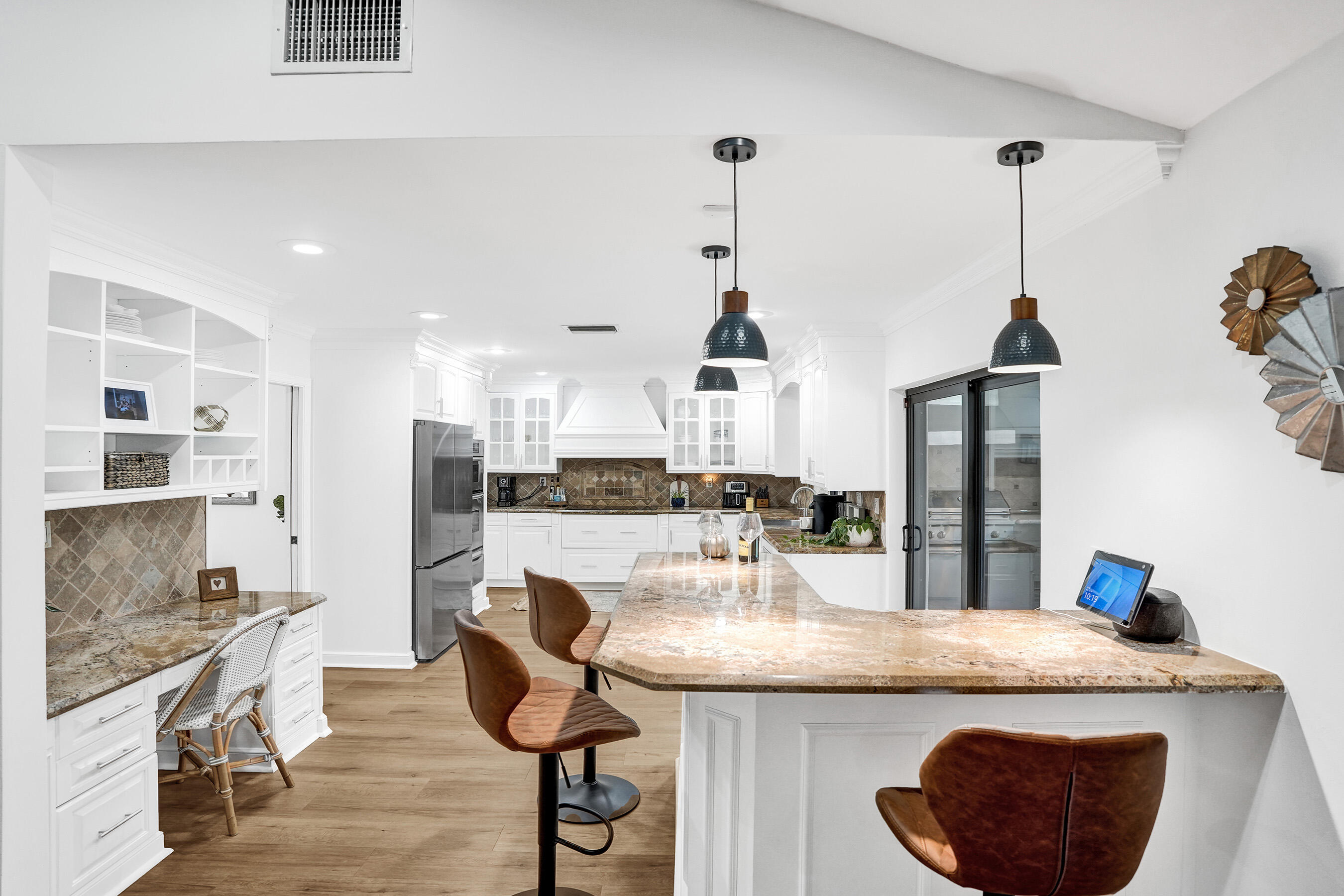 2413 Northwest 40th Circle Boca Raton, FL 33431 - Photo 23 of 66 a kitchen with granite countertop kitchen island stainless steel appliances and chairs