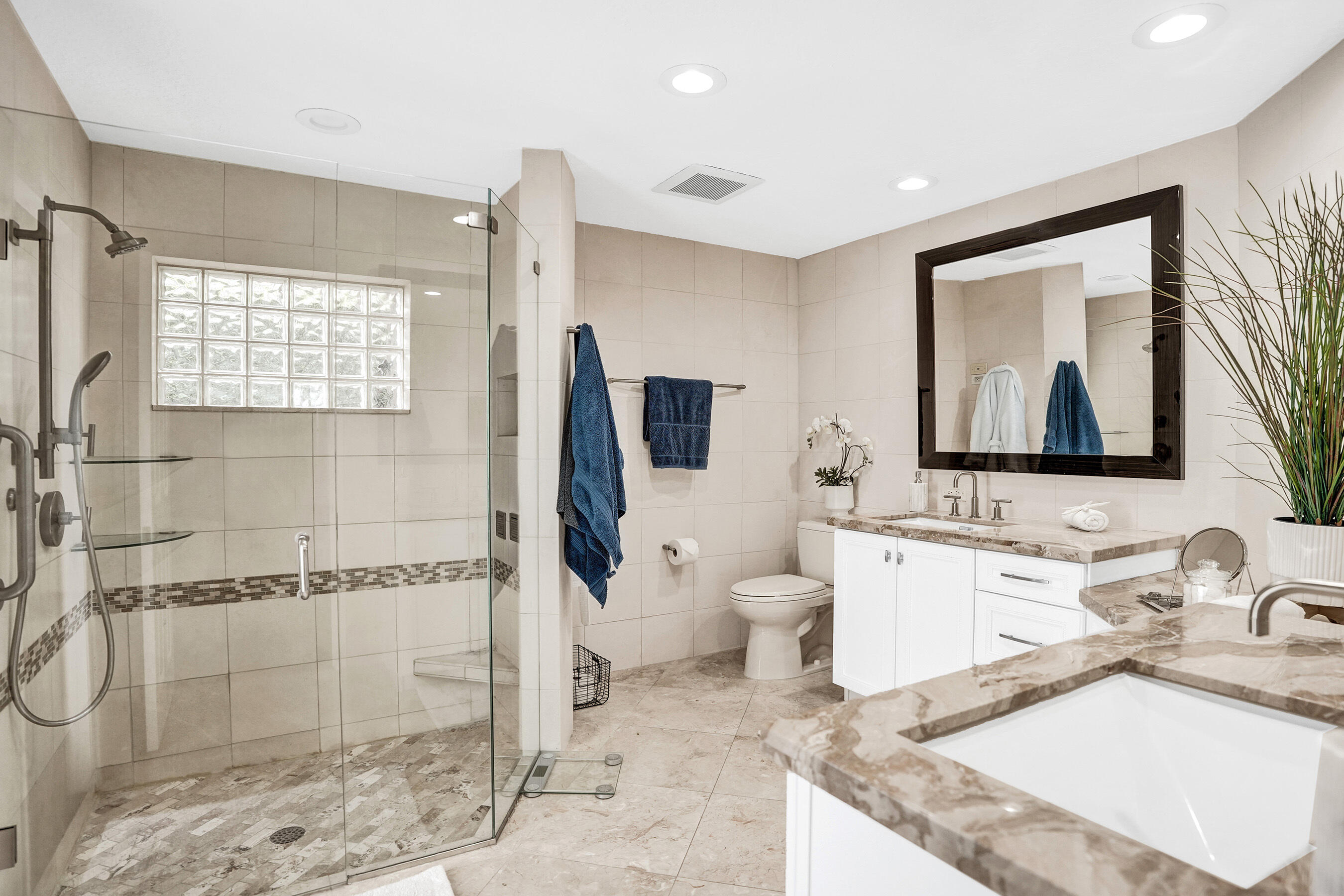 2413 Northwest 40th Circle Boca Raton, FL 33431 - Photo 28 of 66 a bathroom with a granite countertop sink mirror vanity and toilet