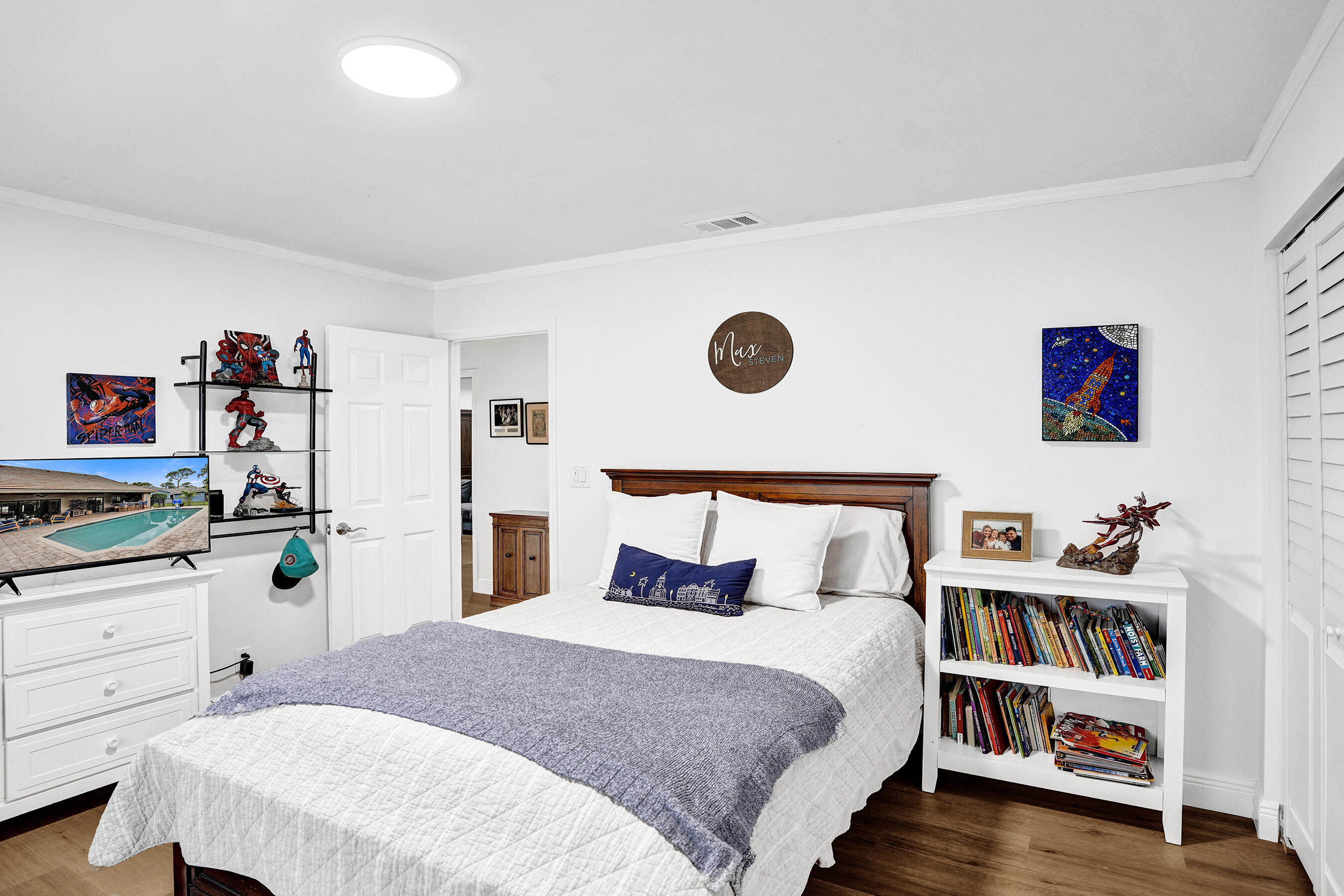 2413 Northwest 40th Circle Boca Raton, FL 33431 - Photo 35 of 66 a bedroom with a bed and a book shelf