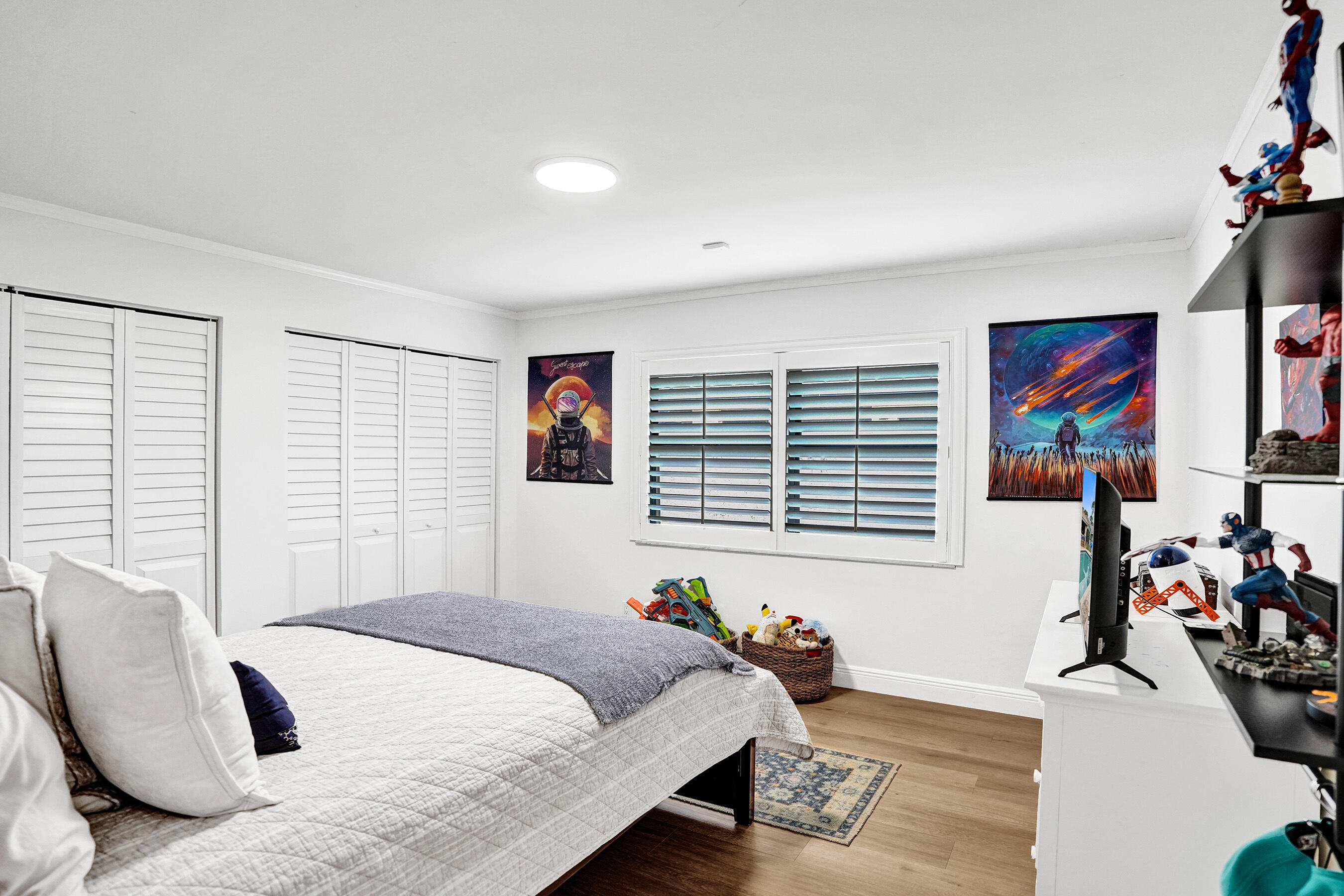 2413 Northwest 40th Circle Boca Raton, FL 33431 - Photo 36 of 66 a bedroom with furniture and a flat screen tv