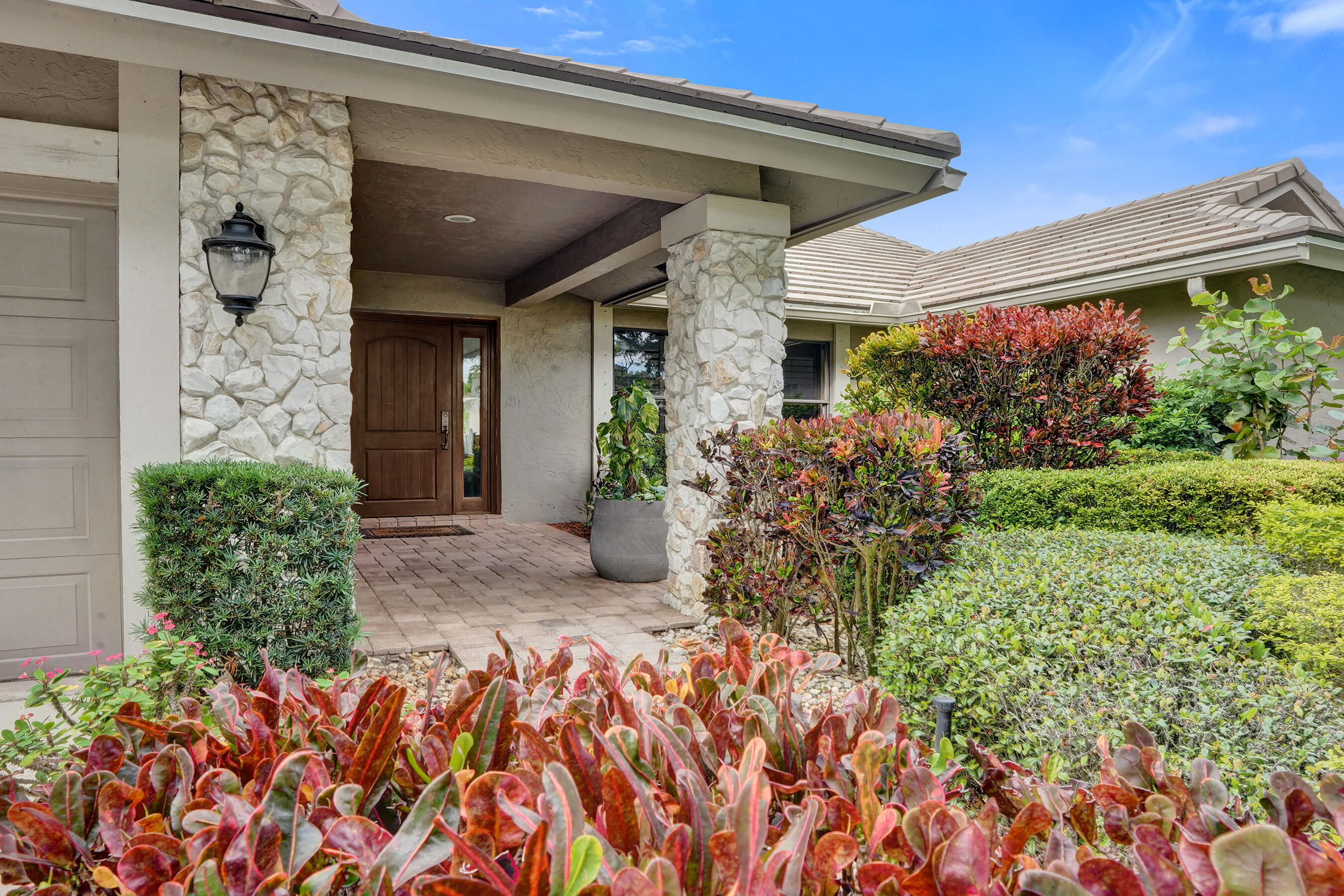 2413 Northwest 40th Circle Boca Raton, FL 33431 - Photo 4 of 66 front view of a house with a large window and potted plants