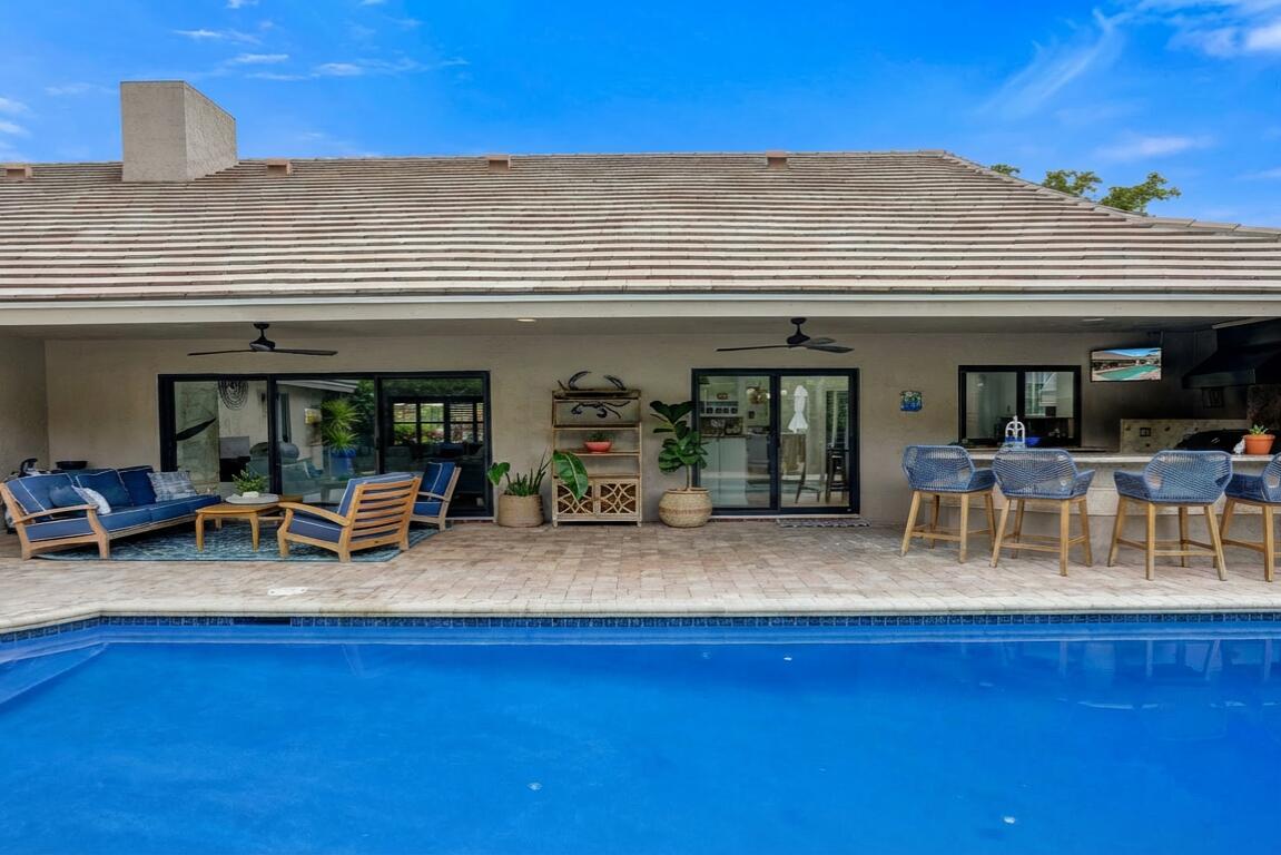 2413 Northwest 40th Circle Boca Raton, FL 33431 - Photo 41 of 66 a view of a patio with table and chairs and potted plants