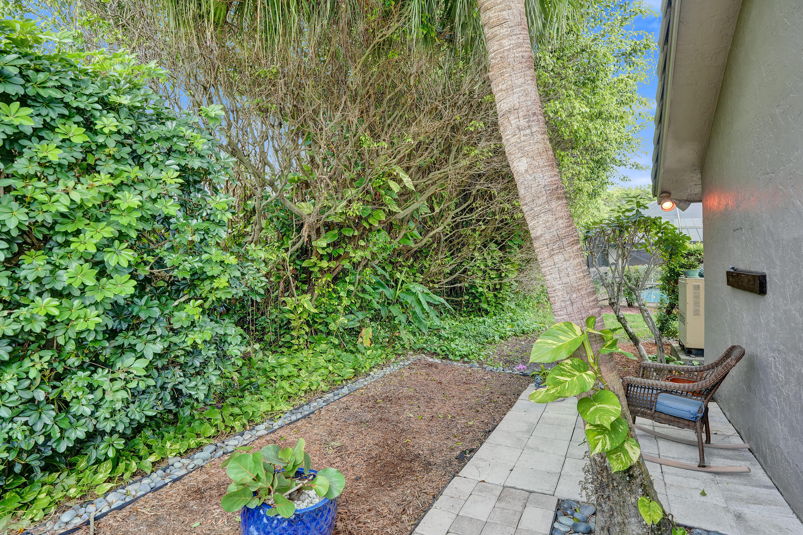 2413 Northwest 40th Circle Boca Raton, FL 33431 - Photo 51 of 66 a view of a patio with table and chairs and potted plants