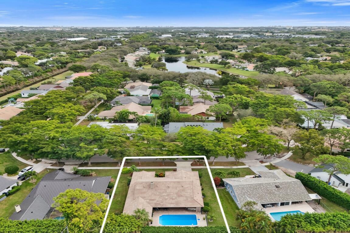 2413 Northwest 40th Circle Boca Raton, FL 33431 - Photo 55 of 66 an aerial view of residential houses with outdoor space and trees
