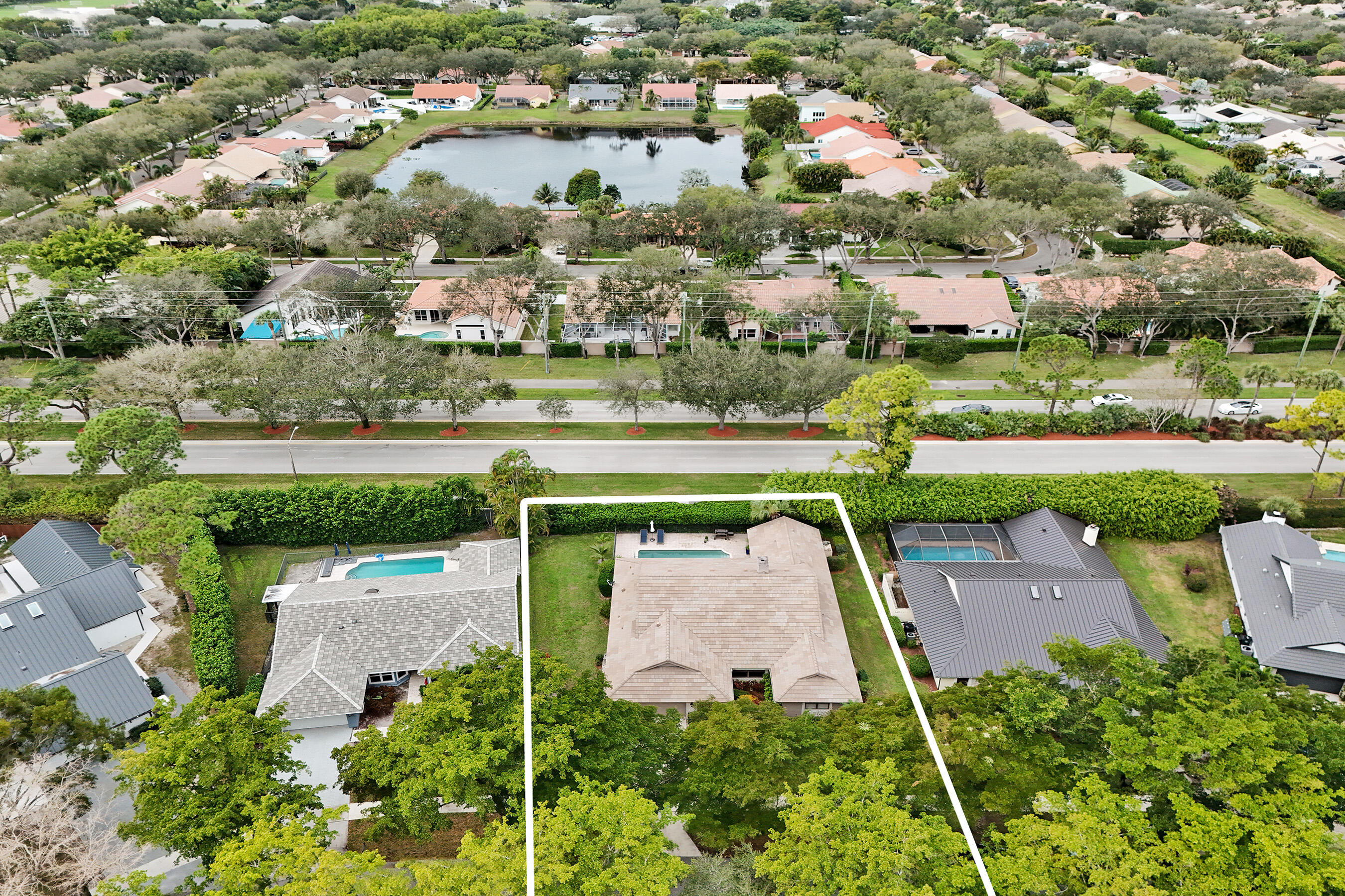 2413 Northwest 40th Circle Boca Raton, FL 33431 - Photo 57 of 66 an aerial view of a house with a garden and lake view