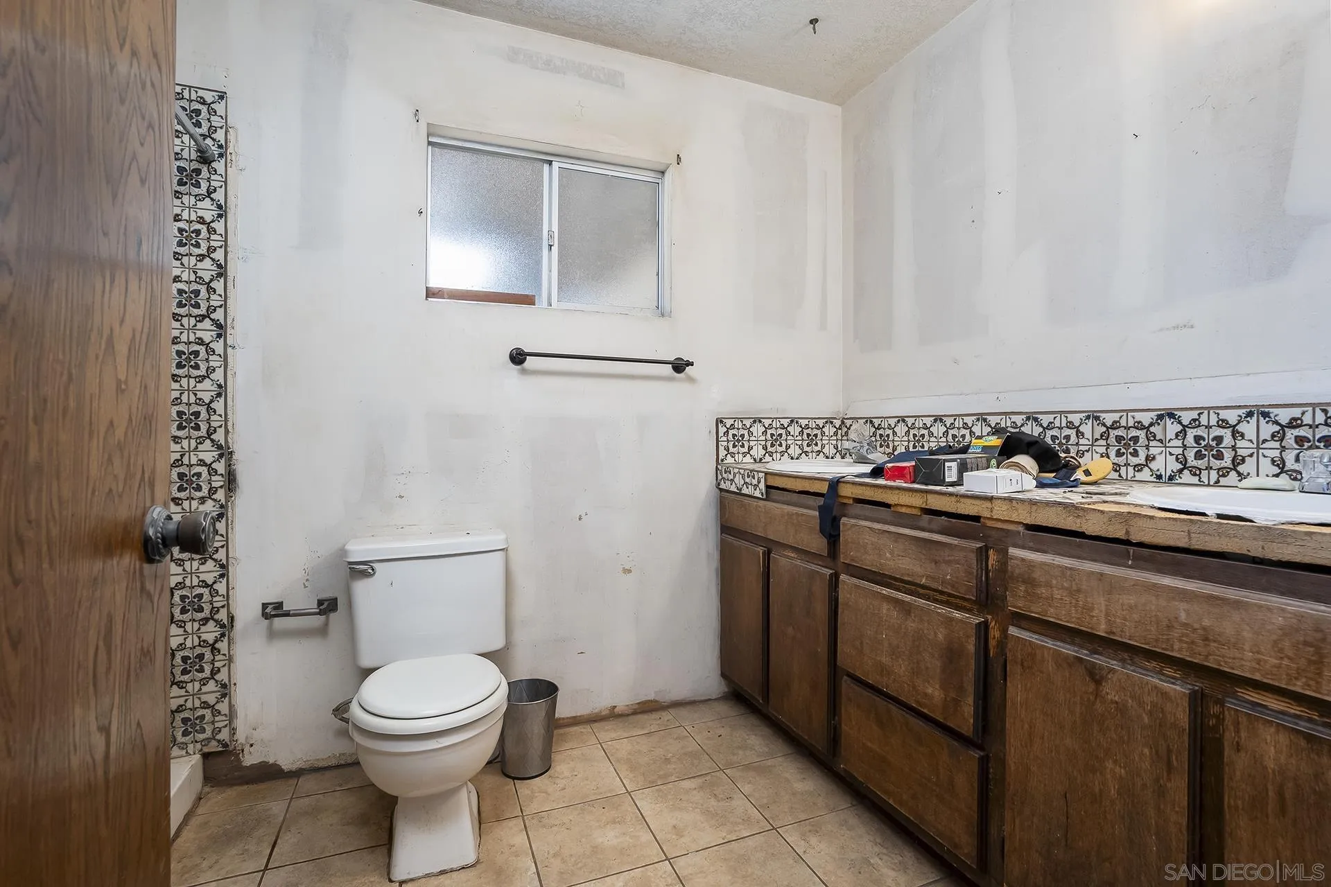4829 Dehesa Road El Cajon, CA 92019 - Photo 7 of 14 a bathroom with a toilet sink and mirror