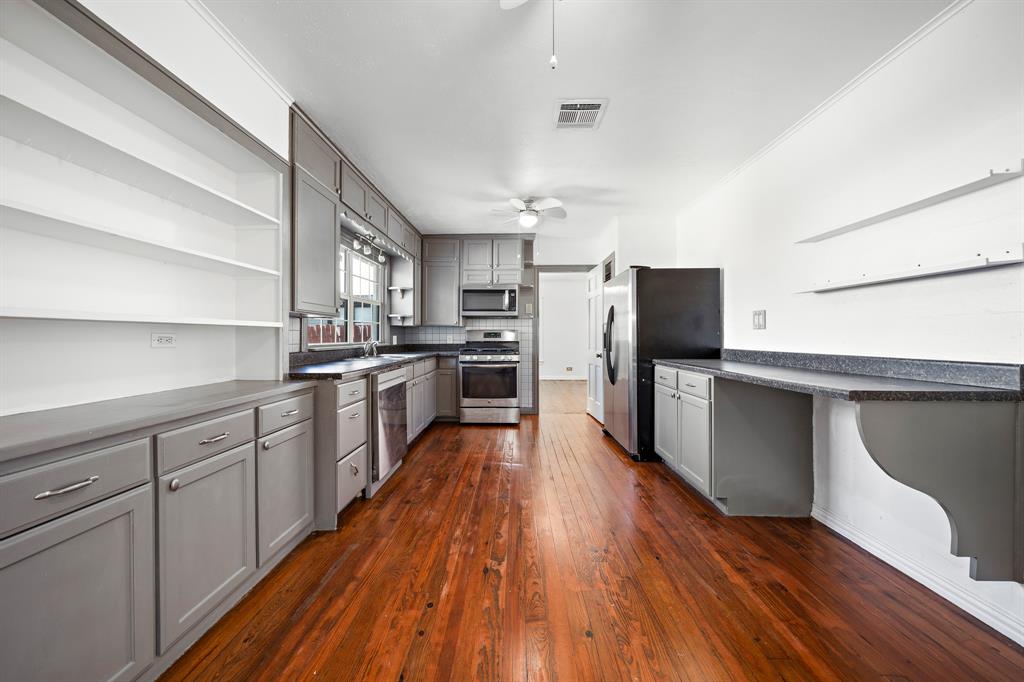 3119 Trice Avenue Waco, TX 76707 - Photo 25 of 40 a large kitchen with stainless steel appliances and wooden floor