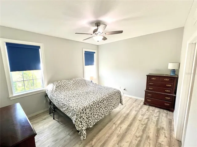 a bedroom with a bed window and dresser