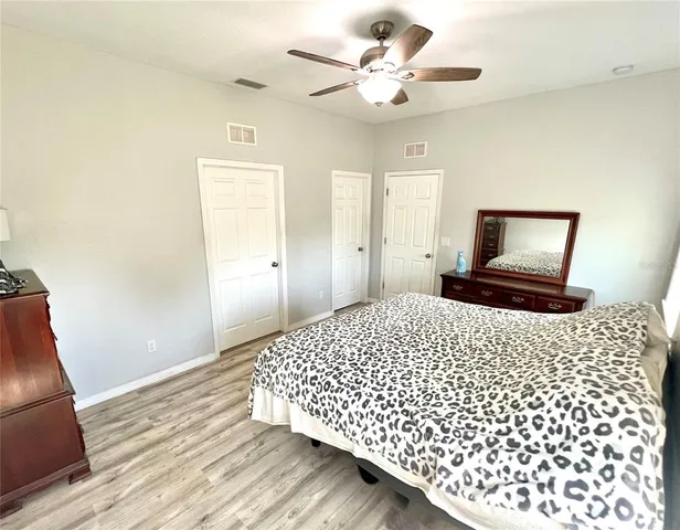 a bedroom with a large bed and a chandelier